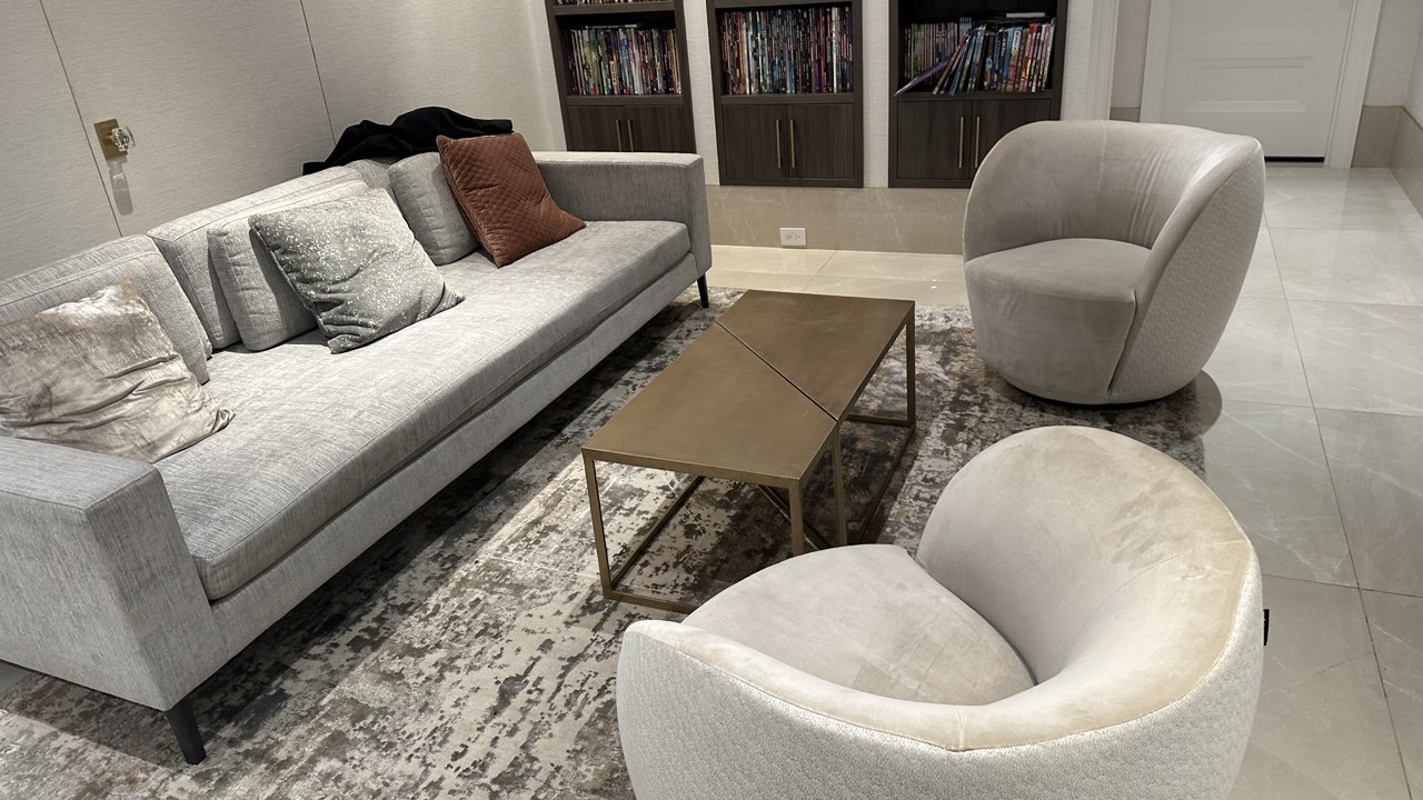 Patterned area rug beneath a sofa and armchairs