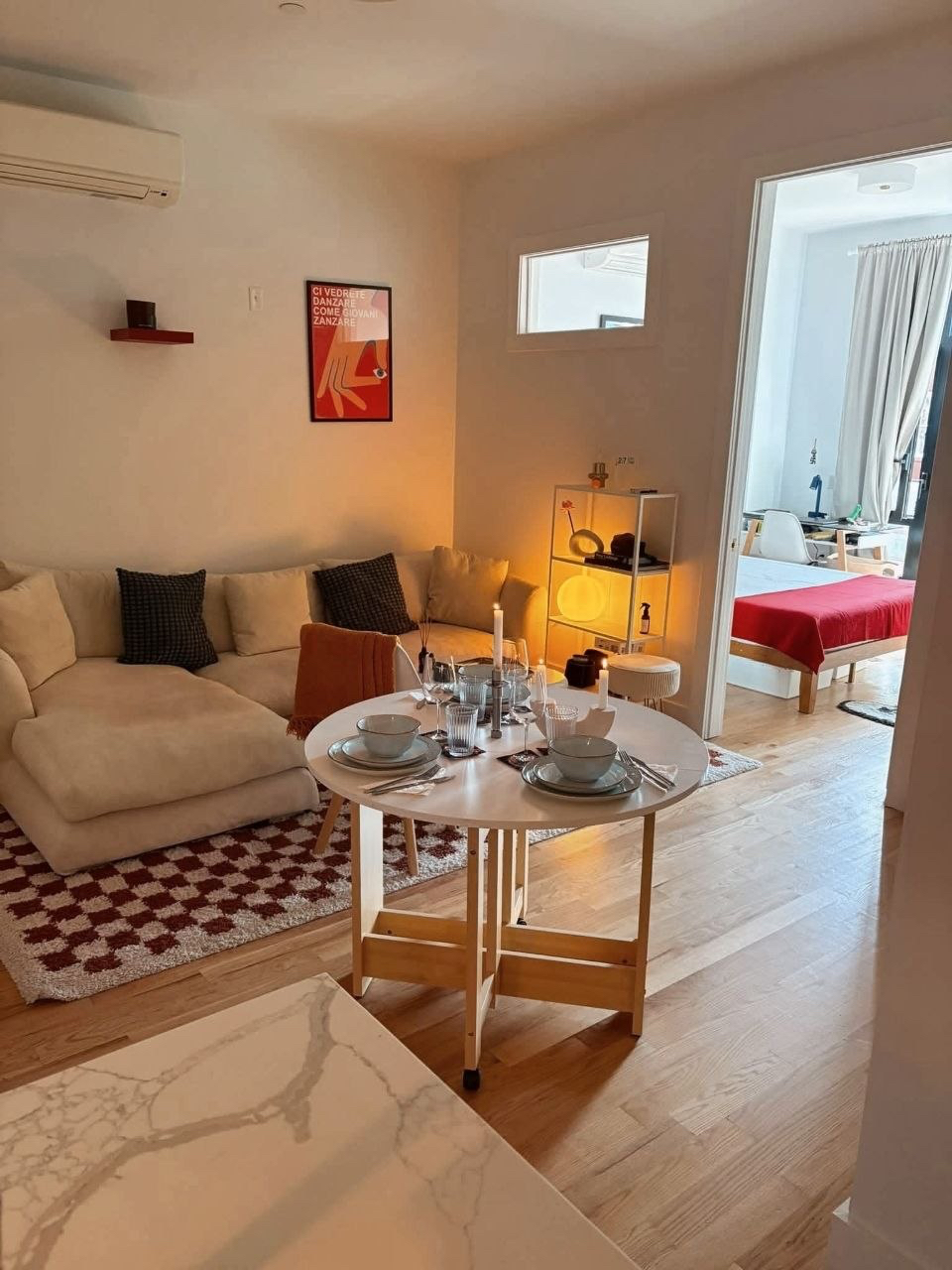 Living and dining area with wood flooring.