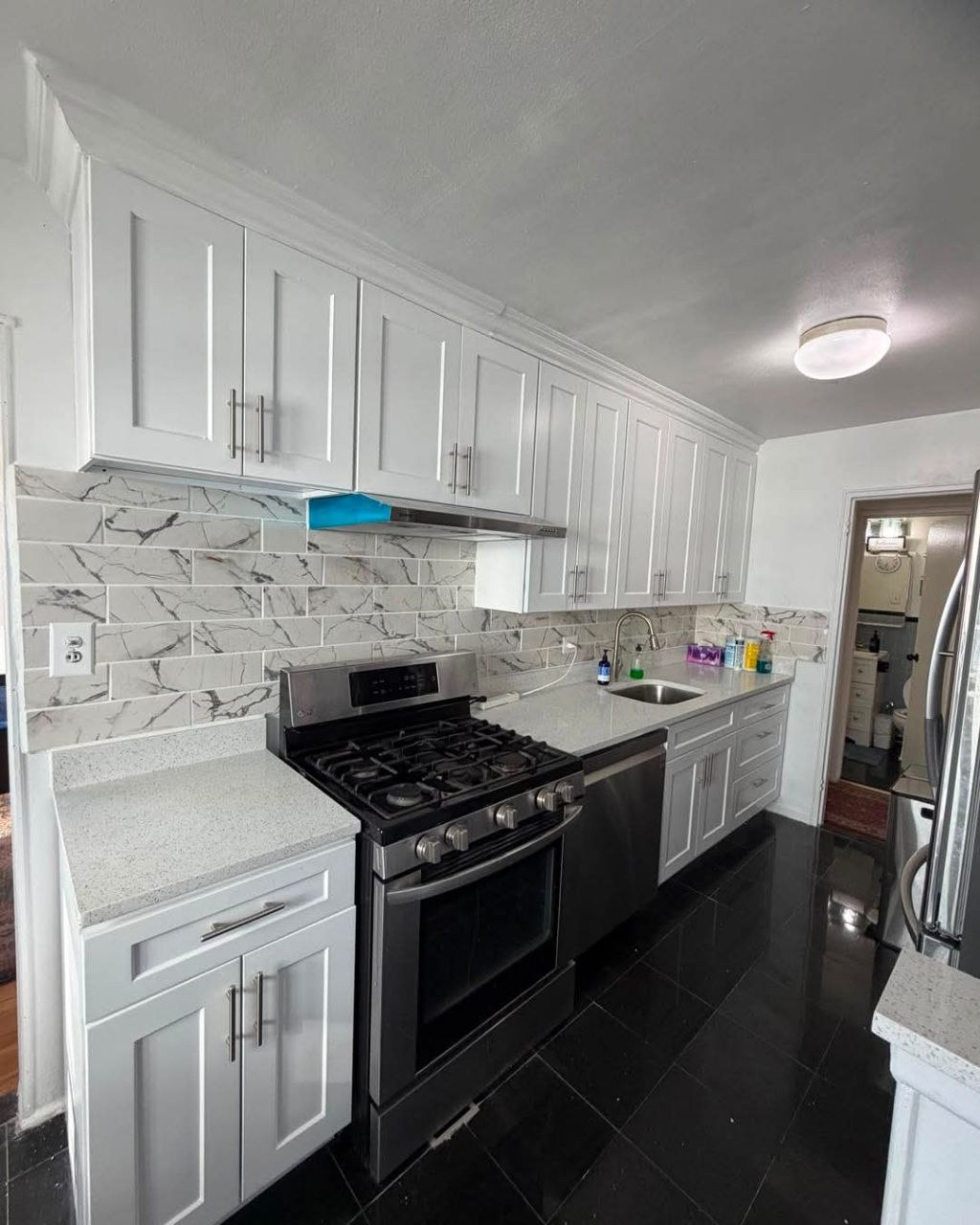 White kitchen, stove and clean counters.