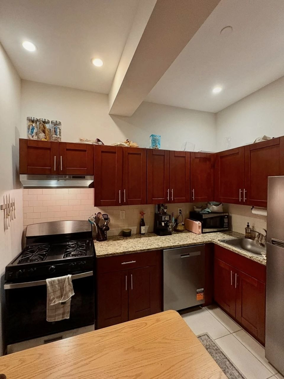 Wood kitchen cabinets, stove and countertops.