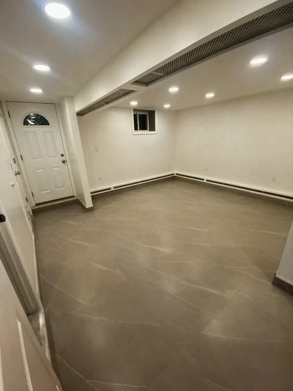 Empty living space with tile flooring.