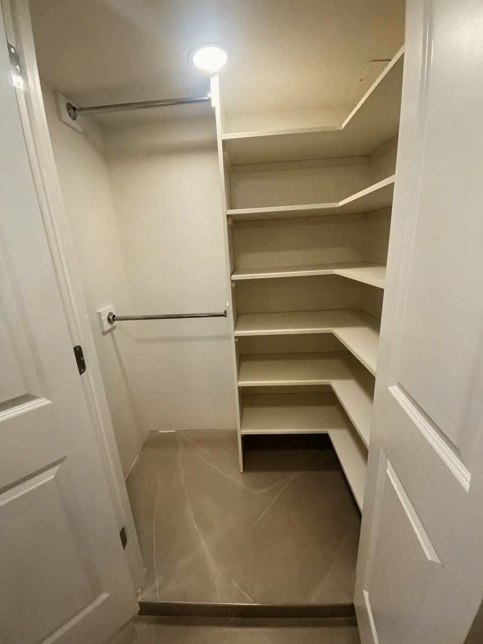 Empty storage closet with built-in shelves.