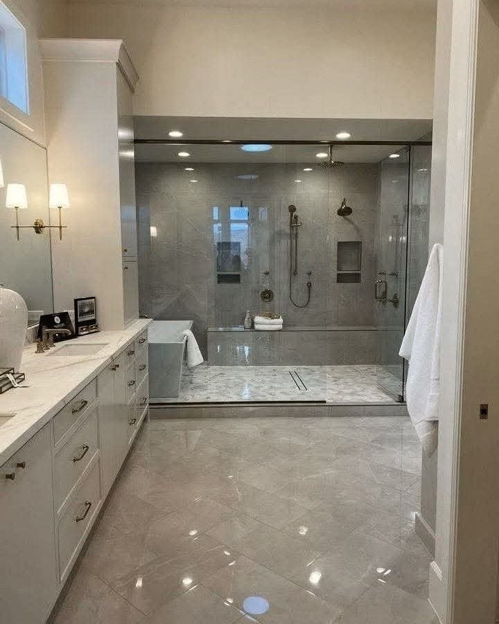 Bathroom with a glass shower and polished tile.