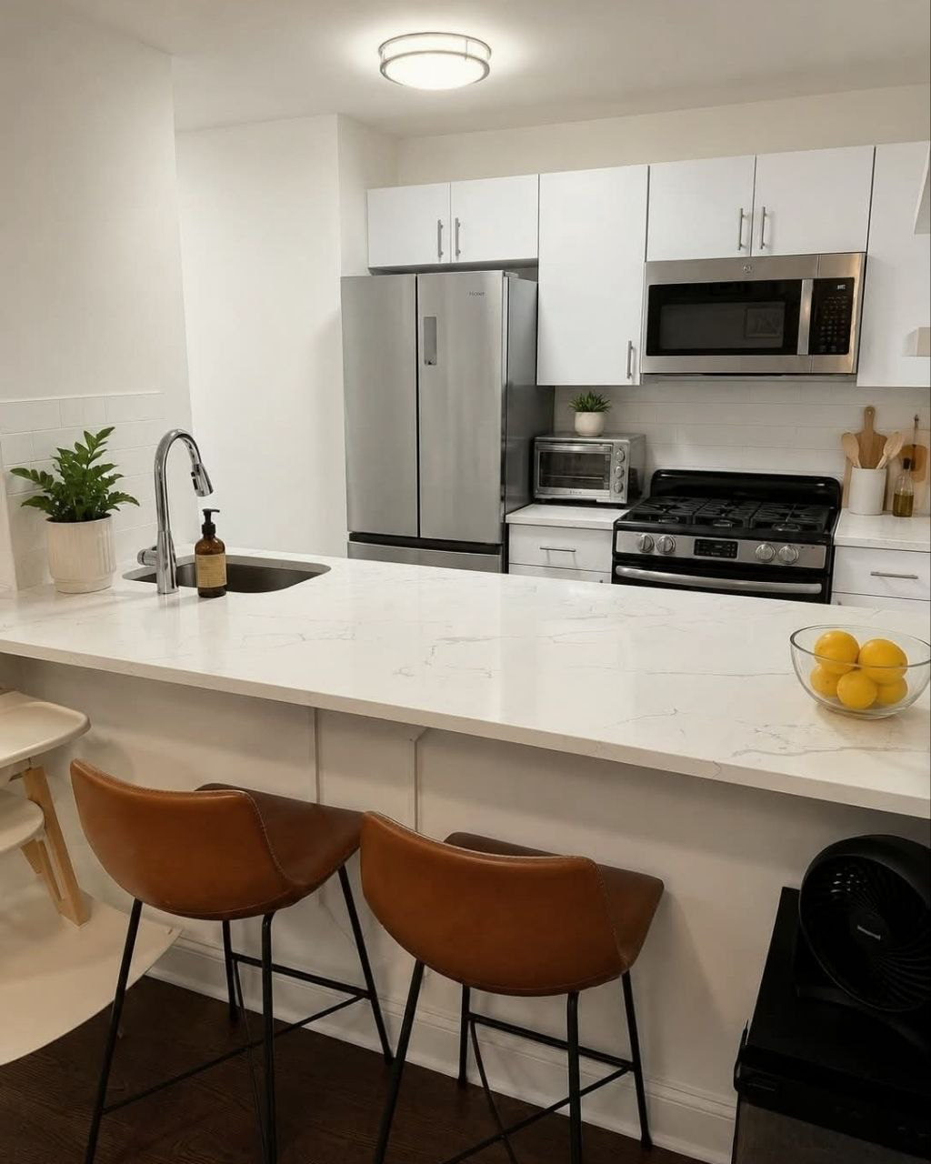 White kitchen with a breakfast counter.